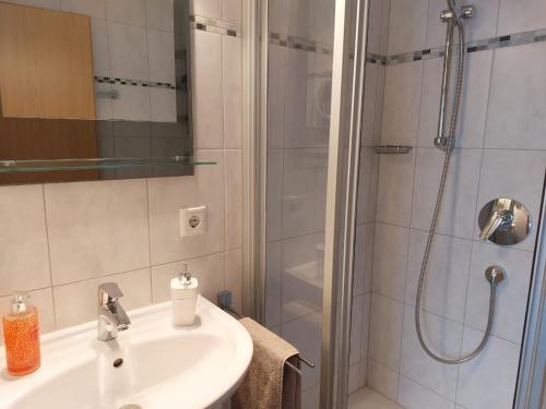 a bathroom with a sink and a shower at Gerlindes Haus - inkl. Chiemgau-Karte in Siegsdorf