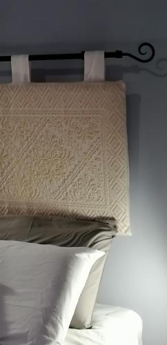 a close up of a bed with a pillow at Il Giardino di Maura - Aemme2 in Recanati