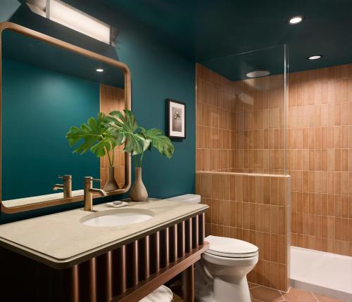 a bathroom with a sink and a toilet and a shower at Mayfair House Hotel & Garden in Miami