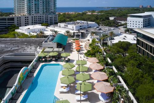an aerial view of a resort with a pool and umbrellas at Mayfair House Hotel & Garden in Miami