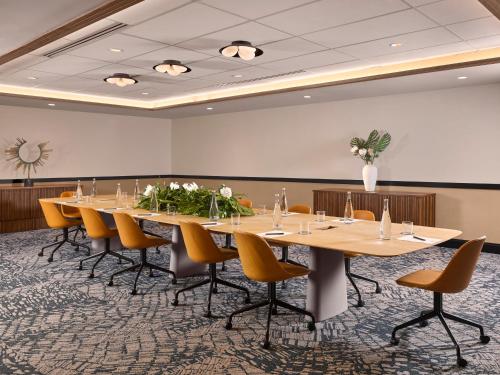 a conference room with a long table and chairs at Mayfair House Hotel & Garden in Miami
