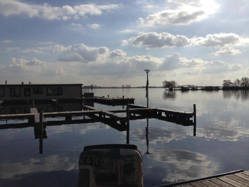 a view of a body of water with a dock at VISSERSLUST Rooms, Apartments and Houseboats in Vinkeveen