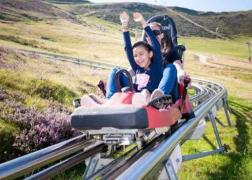 a group of people riding on a roller coaster at le Pargagnat in Préchac