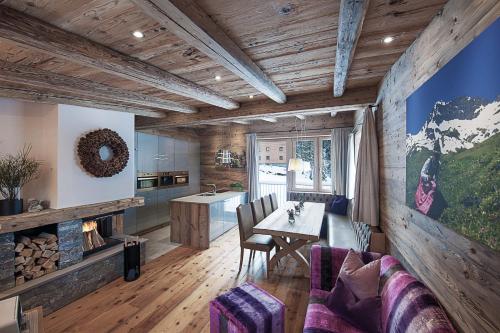 a kitchen and living room with a table and chairs at Vital Chalet Edelweiss in Schröcken
