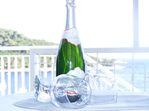 a bottle of wine sitting on top of a table at Apartments by the sea Cove Saplunara, Mljet - 12849 in Maranovići