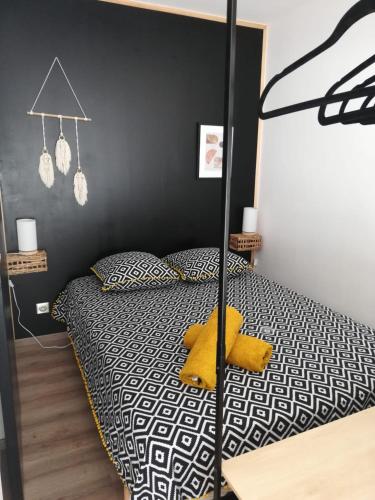 a bedroom with a bed with a yellow teddy bear on it at STUDIO A 2 MN DE L A75 in Usclas-lʼHérault