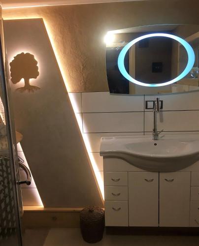 a bathroom with a sink and a mirror at Oak apartment in Březnice