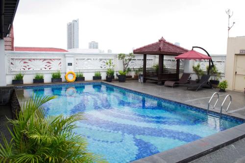 a swimming pool with a gazebo on a building at Arion Suites Hotel Kemang in Jakarta