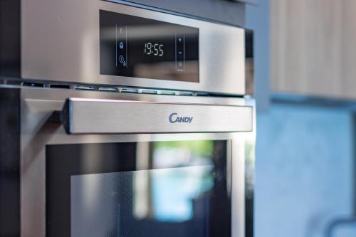 a kitchen with an oven with a clock on it at Apartment Tamara Suite - Menaggio in Menaggio