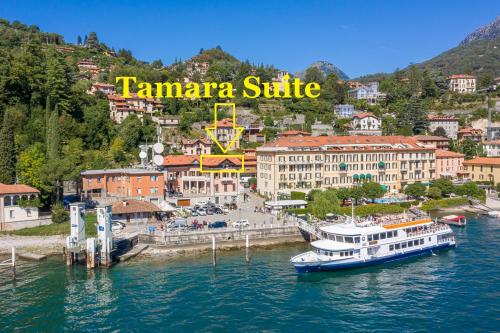 a boat is docked in the water near a city at Apartment Tamara Suite - Menaggio in Menaggio