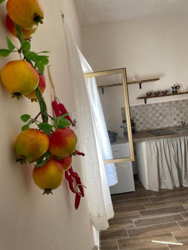 a bunch of fruit hanging on a wall at Casa Buena Vida (locazione ad uso turistico) in Monopoli