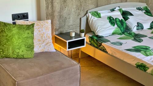 a bedroom with a bed with a chair and a table at Vrachokipos Guesthouse in Kokkini Khanion