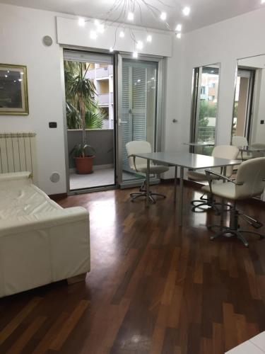 a living room with a table and chairs and a couch at Casa delle sorprese in Pescara