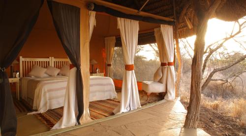 a bedroom with a bed in a tent at Elewana Lewa Safari Camp in Meru