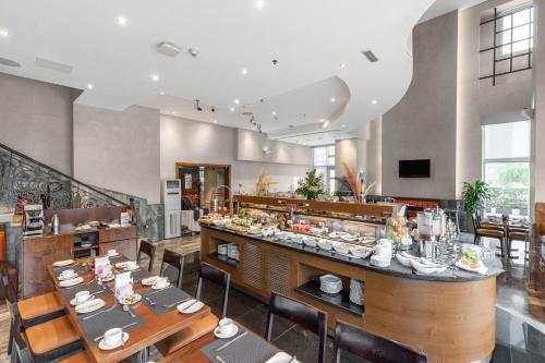 un restaurante con mesas y sillas y un bar en City Premiere Hotel Apartments - Dubai en Dubái