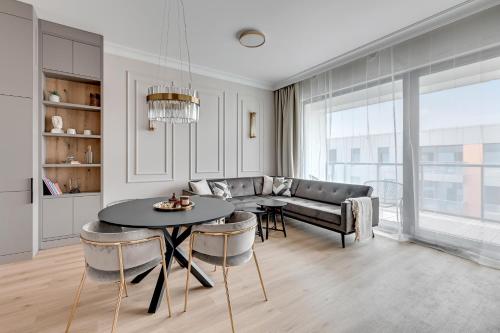 a living room with a couch and a table at Grand Apartments - Brabank Apartments in Gdańsk