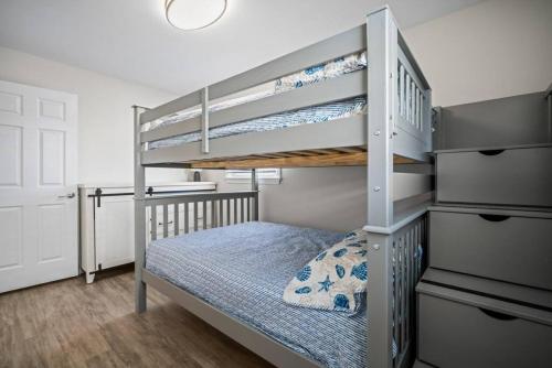 a bedroom with a bunk bed with a ladder at Relax and enjoy the Beach Beautifully updated in Brigantine