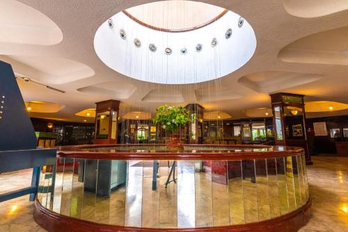 a lobby with a glass table in a building at Nairobi Safari Club by Swiss-Belhotel in Nairobi