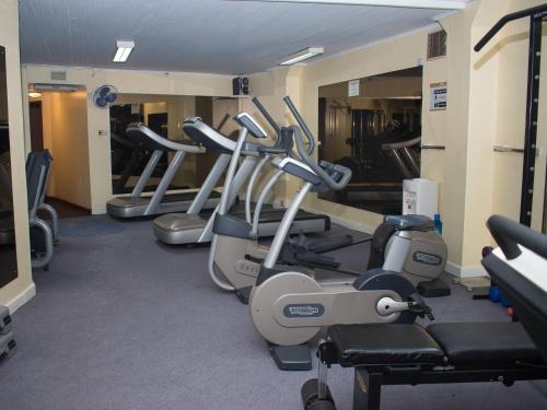 a gym with a row of treadmills and machines at Nairobi Safari Club by Swiss-Belhotel in Nairobi