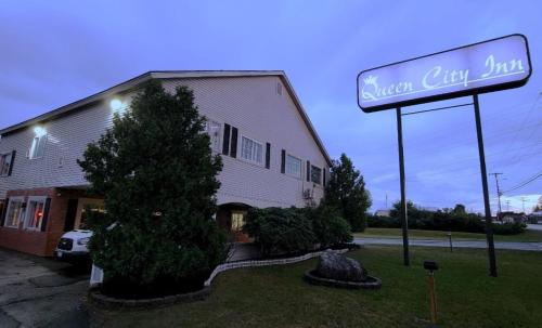 a sign in front of a building with a sign at Queen City Inn in Bangor