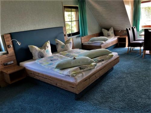 a bedroom with two beds with pillows on them at Gästehaus Ainser in Hagnau