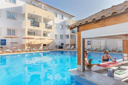 two women sitting in the pool at a hotel at Smy Santa Eulalia Algarve in Albufeira