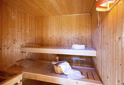 a wooden sauna with two shelves and a basket in it at Perle am Watt in List