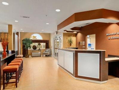 a lobby of a hospital with a counter and chairs at Microtel Inn & Suites by Wyndham Ozark in Ozark