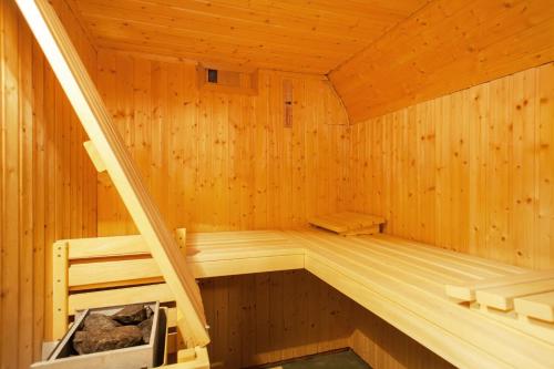 a wooden sauna with a ladder in it at Strandhaus in List