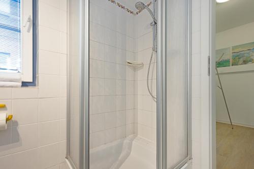 a shower with a glass door in a bathroom at Cap Blanco in List