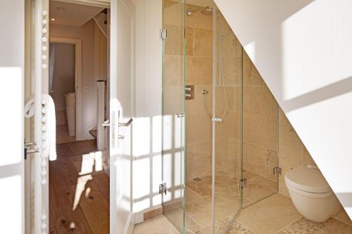 a bathroom with a shower and a toilet at Sunset in List