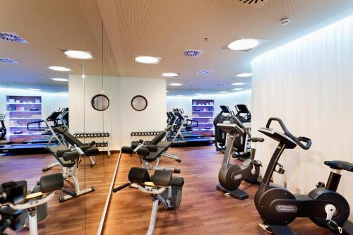 a gym with treadmills and elliptical machines at Grand Hotel Wien in Vienna