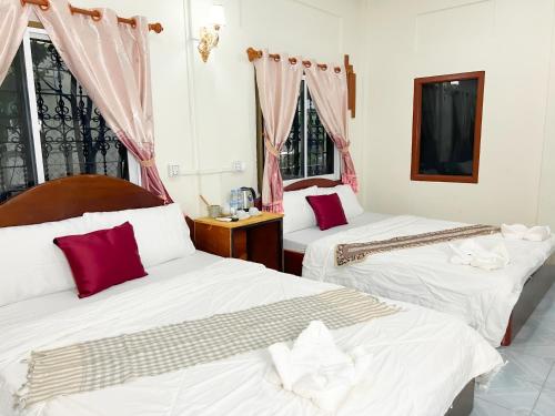 Ένα ή περισσότερα κρεβάτια σε δωμάτιο στο Lotus Blanc Homestay