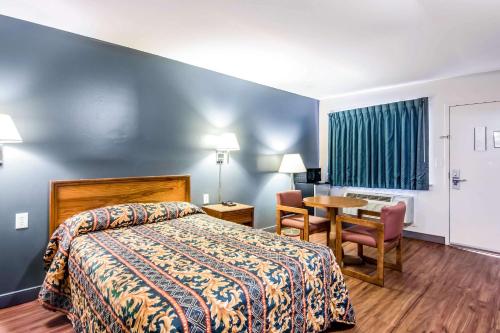 a hotel room with a bed and a table at Rodeway Inn North Chesterfield-Richmond in Richmond