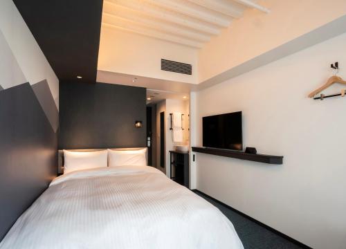 Ένα ή περισσότερα κρεβάτια σε δωμάτιο στο Prince Smart Inn Kyoto Sanjo