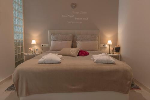 a bedroom with a large bed with two pillows on it at B&B Villa Deseada in Periana