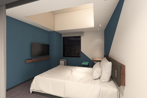 Postel nebo postele na pokoji v ubytování Prince Smart Inn Hakata