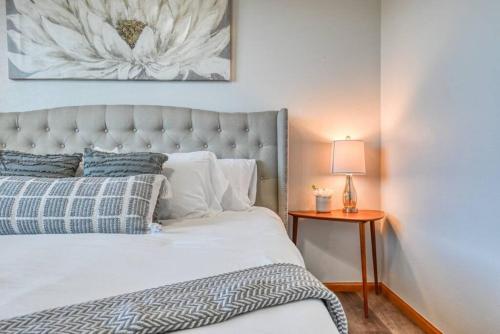 a bedroom with a bed and a lamp on a table at Family Retreat 5 Min to USAFA with Mtn Views in Colorado Springs