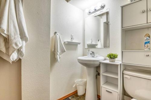 a white bathroom with a sink and a mirror at Family Retreat 5 Min to USAFA with Mtn Views in Colorado Springs