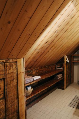 an attic room with wooden ceilings and a bed at Kalnciema kvartāla Kuldīgas rezidence in Kuldīga