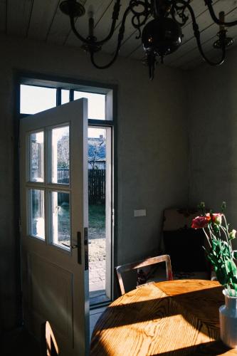 a room with a table and a door with a window at Kalnciema kvartāla Kuldīgas rezidence in Kuldīga