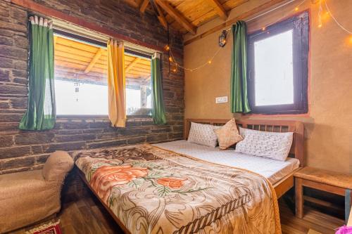 a bedroom with a bed in a room with windows at Zenoaks Homestay in Almora