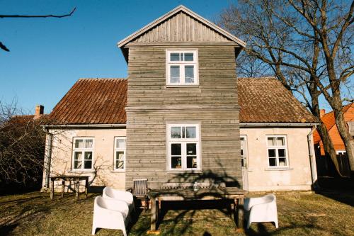 a house with a table and chairs in front of it at Kalnciema kvartāla Kuldīgas rezidence in Kuldīga