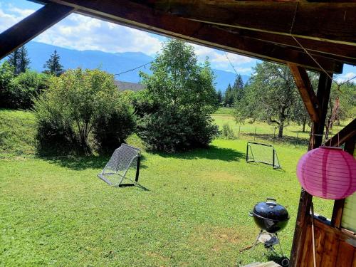 a view of a yard with two chairs in the grass at Haus Branol in Hermagor