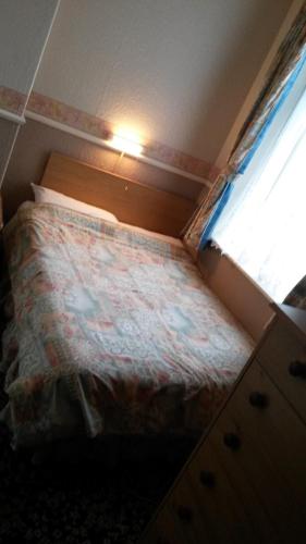 a small bedroom with a bed and a window at Walford Hotel in Blackpool