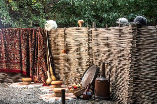 a wicker fence with a bunch of items on it at Hotel Adamo in Tbilisi City