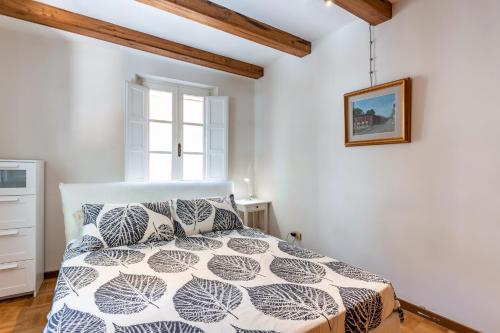 a bedroom with a bed and a window at Piazza Napoleone Lovely Central Apartment in Lucca