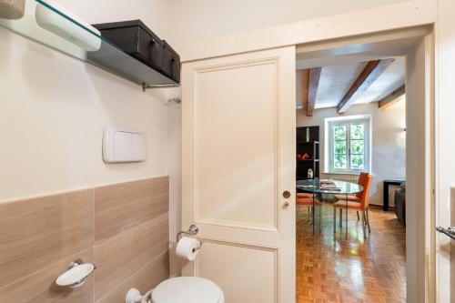 a bathroom with a toilet and a table at Piazza Napoleone Lovely Central Apartment in Lucca
