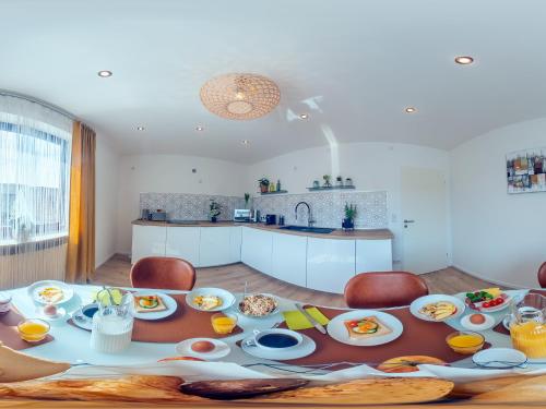 a table with plates of food on it in a kitchen at Zwick Apartments in Kammerstein