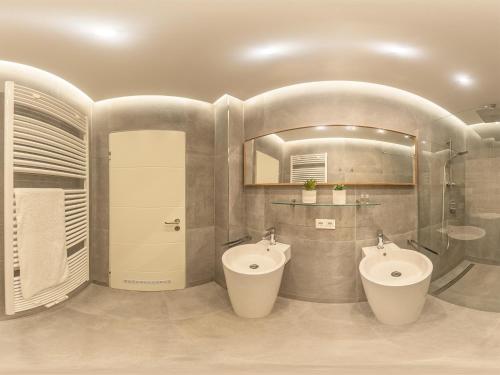 a bathroom with two sinks and two toilets at Zwick Apartments in Kammerstein